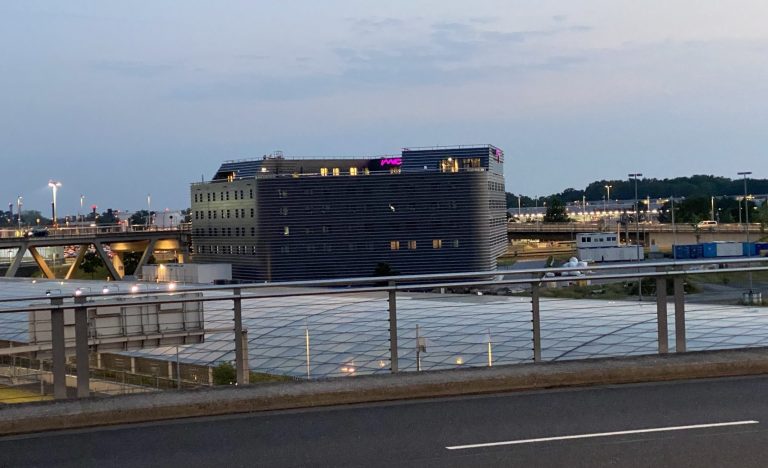 Hotel Moxy Köln Airport - Ansicht von der umgebenden Flughafenstraße.